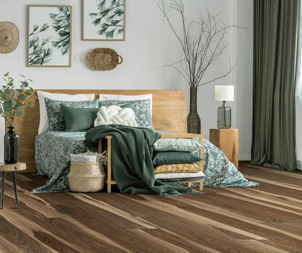 Luxury Vinyl Plank in bedroom setting featuring a bed, drapes, and decor with earthy green tones.